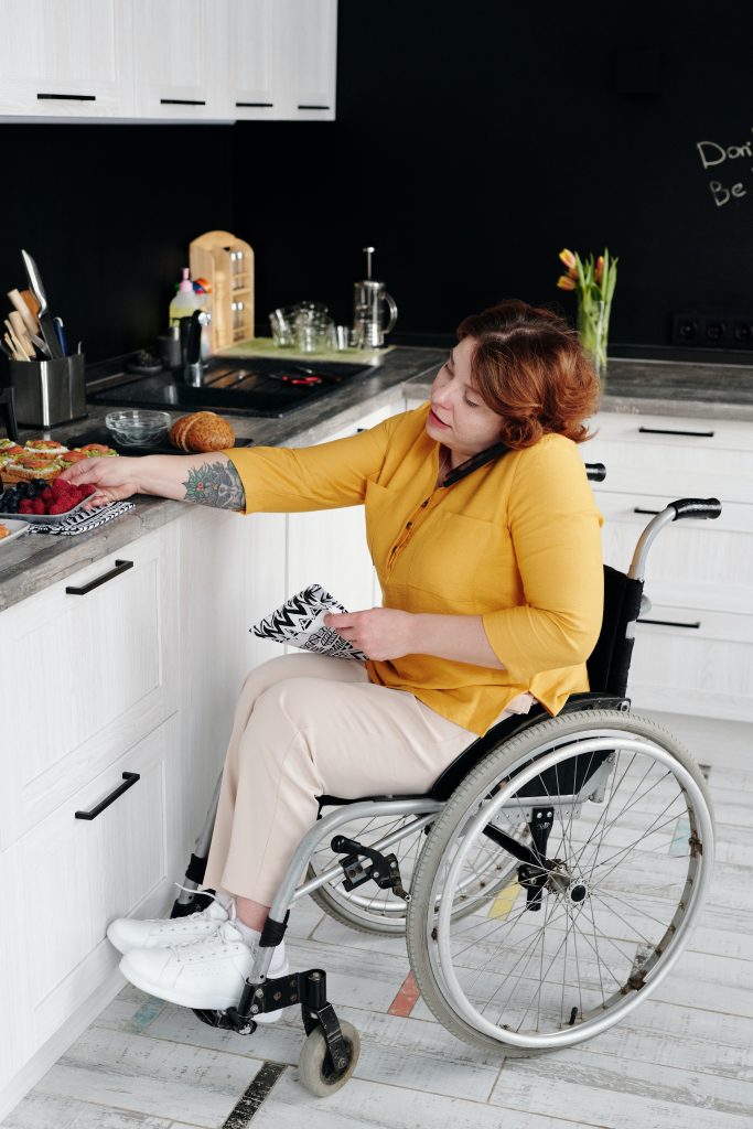 Photo of person with disability preparing food in kitchen